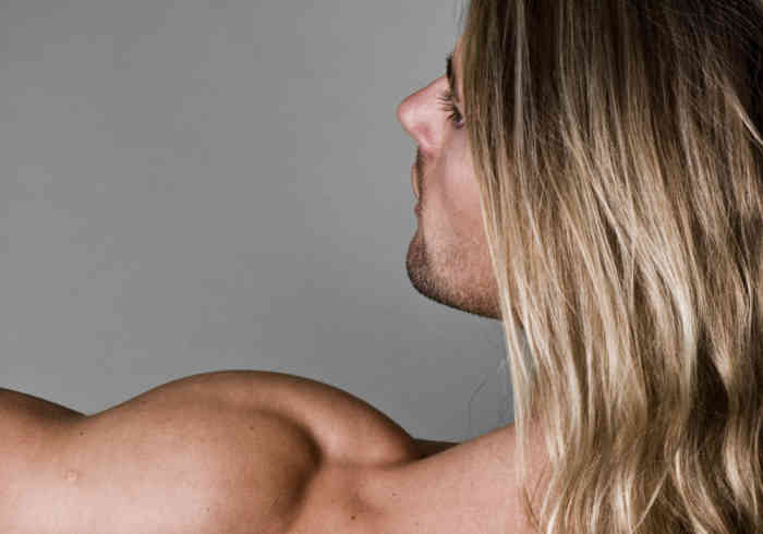 Male body builder back with long hair | Does MK-677 Cause Hair Loss?